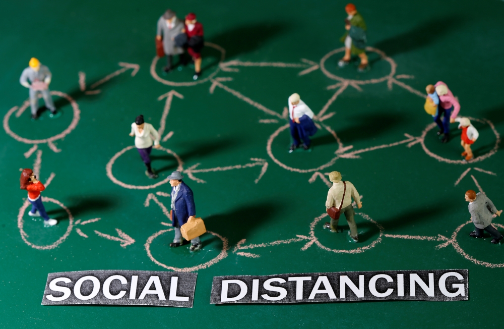 Small toy figures are placed on a chalkboard near 