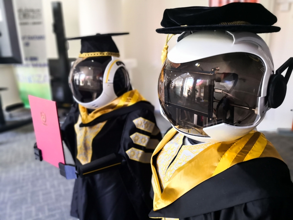 This undated handout photo released by the University Sultan Zainal Abidin on June 2, 2020 shows two robots named Seebaa (R) and Naseem (L) wearing graduation robes are pictured during a simulation in Terengganu. AFP PHOTO / UNIVERSITY SULTAN ZAINAL ABIDI