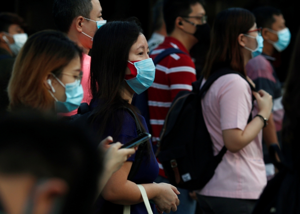 People cross a street during morning peak hour commute amid the coronavirus disease (COVID-19) outbreak in Singapore June 3, 2020. REUTERS/Edgar Su

