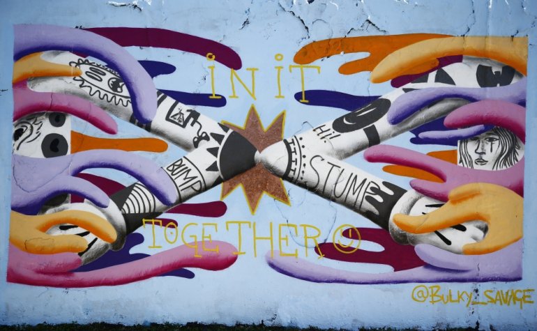 FILE PHOTO: BERLIN, GERMANY - APRIL 27: A graffiti to draw attention to novel coronavirus (Covid-19) pandemic is seen at Mauer Park in Berlin, Germany on April 27, 2020. ( Abdulhamid Ho?ba? - Anadolu Agency )
