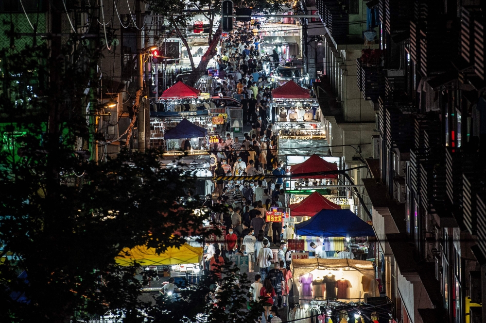 TOPSHOT - This photo taken on June 3, 2020 shows people visiting a night market in Wuhan in China's central Hubei province. China OUT / AFP / STR