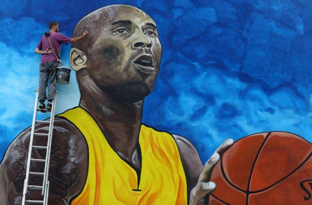 Artist Deni Bozic (27) paints the last details on his tribute mural honoring former Los Angeles Lakers basketball star Kobe Bryant on a school building wall in Gradiska, Bosnia and Herzegovina June 8, 2020. Picture taken June 8, 2020. REUTERS/Dado Ruvic

