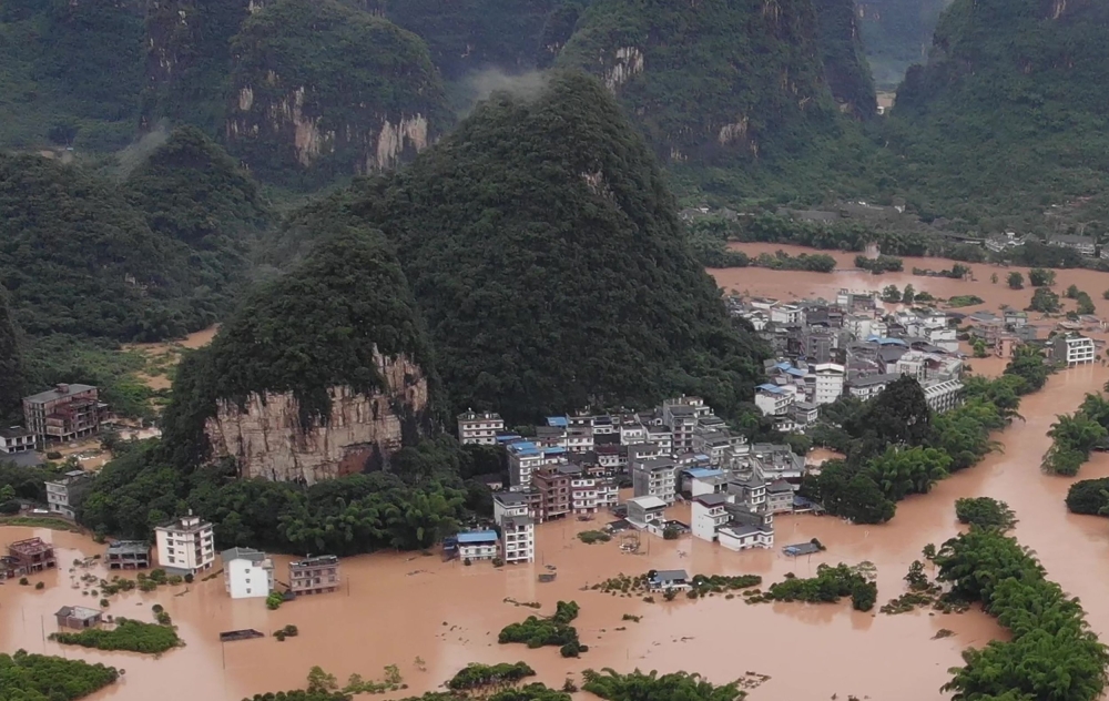 TOPSHOT - This photo taken on June 7, 2020 shows submerged streets and inundated buildings after heavy rain caused flooding in Yangshuo, in China's southern Guangxi region. / AFP / STR

