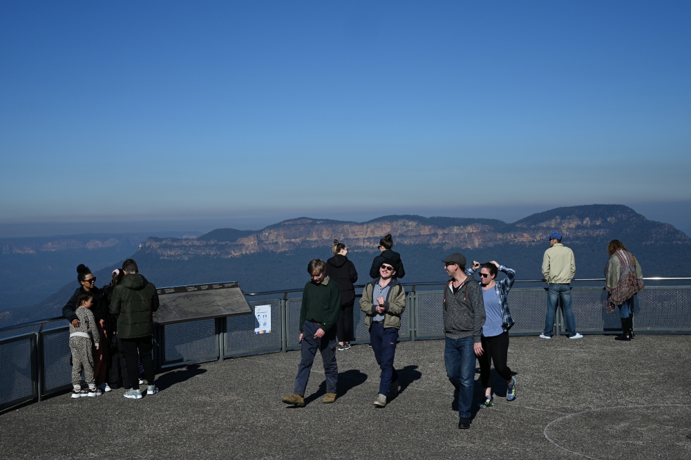 Tourists take in the view at a Three Sisters rock formation lookout in Blue Mountains National Park in the wake of regional travel re-opening as the coronavirus disease (COVID-19) restrictions are eased in New South Wales, in Katoomba, Australia, June 5, 