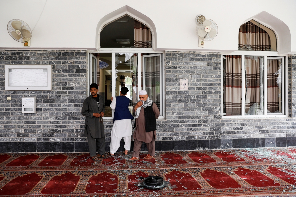 Men inspect the site of a blast inside a mosque in Kabul, Afghanistan June 12, 2020.REUTERS/Mohammad Ismail