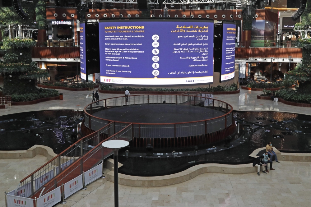 A digital sign displaying COVID-19 information is pictured at the Mall of Qatar following its reopening in the capital Doha on June 15, 2020, as the country gradually lifts its Covid-19 lockdown. / AFP / KARIM JAAFAR