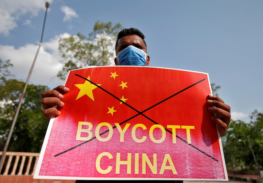 A member of National Students' Union of India (NSUI) holds a placard during a protest against China, in Ahmedabad, India, June 18, 2020. REUTERS/Amit Dave
 