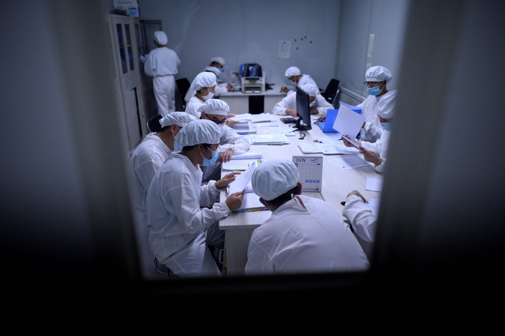 FILE PHOTO: This photo taken on June 10, 2020 shows researchers working in a lab  in China/ AFP / NOEL CELIS / 