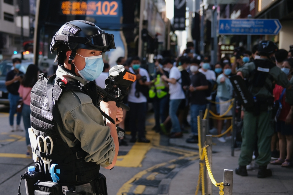 A riot police officer holds a pepper-spray projectile as he stands guard to avoid mass gathering during a protest against the looming national security legislation in Hong Kong, China June 28, 2020. REUTERS/Tyrone Siu
