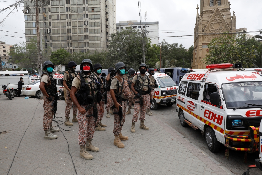 Paramilitary soldiers stand guard at the site of an attack at the Pakistan Stock Exchange in Karachi June 29, 2020. REUTERS/Akhtar Soomro