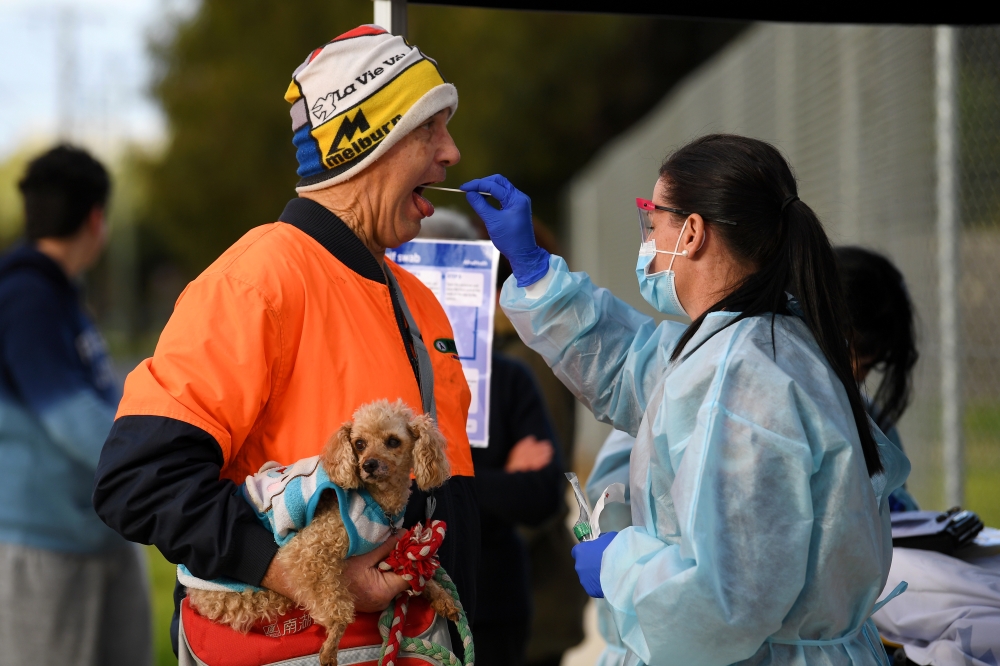 A medical professional administers a test to a member of the public at a pop-up coronavirus disease (COVID-19) testing facility, as the state of Victoria experiences a spike in cases, in Melbourne, Australia, June 26, 2020. AAP Image/James Ross via REUTER