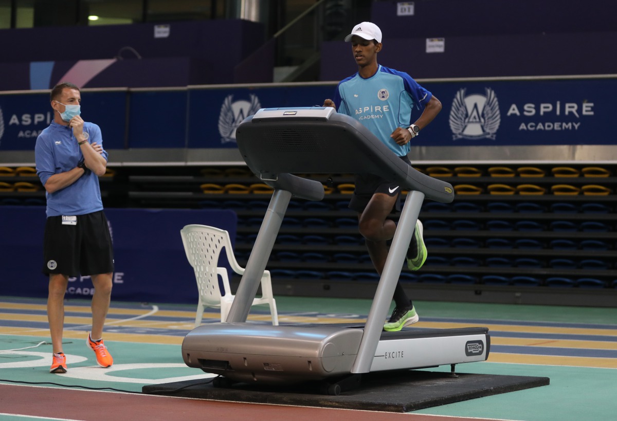 A student athlete of Aspire Academy takes part in a training session under the guidance of a coach. 