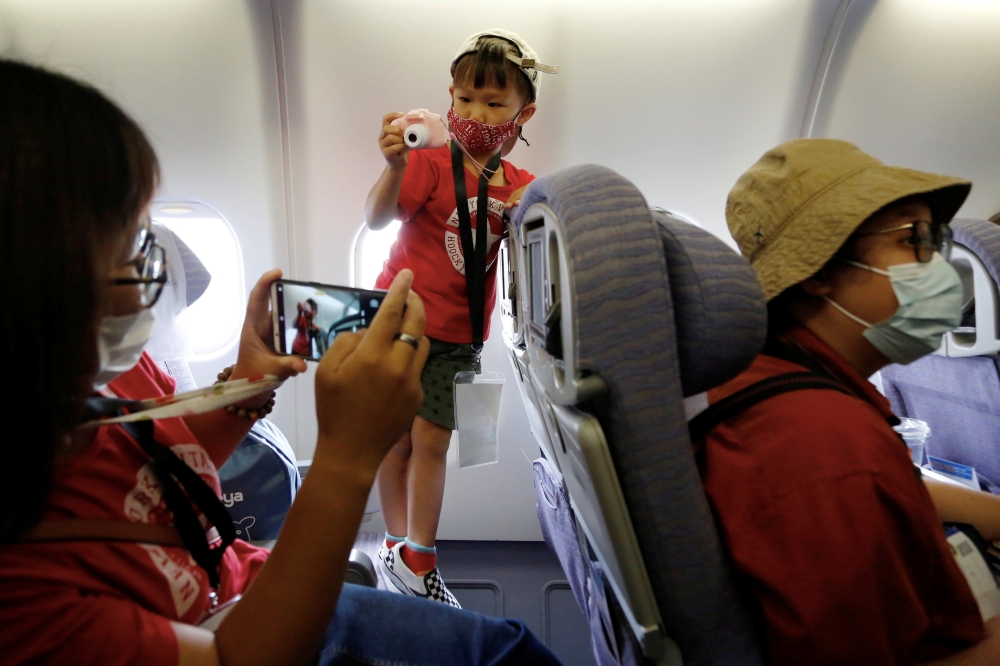 People who want to leave the island, but cannot due to coronavirus disease-related (COVID-19) travel restrictions, take part in a 