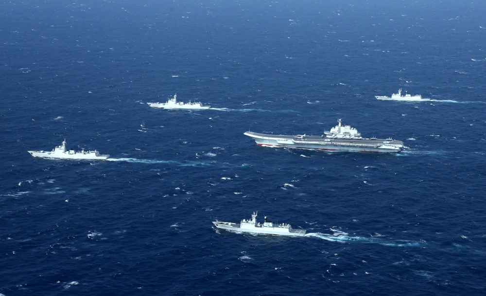 (FILES) This aerial file photo taken on January 2, 2017 shows a Chinese Navy formation, including the aircraft carrier Liaoning (C), during military drills in the South China Sea.  China OUT / AFP / STR
