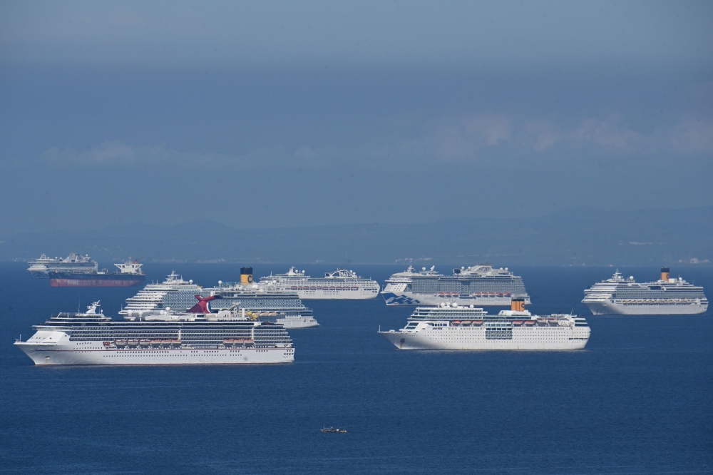 This file photo taken on May 31, 2020 shows a general view of cruise ships anchored at Manila Bay waiting for disembarkation clearance from authorities for their Filipino crews who have undergone swab tests for the COVID-19 coronavirus, according to the P