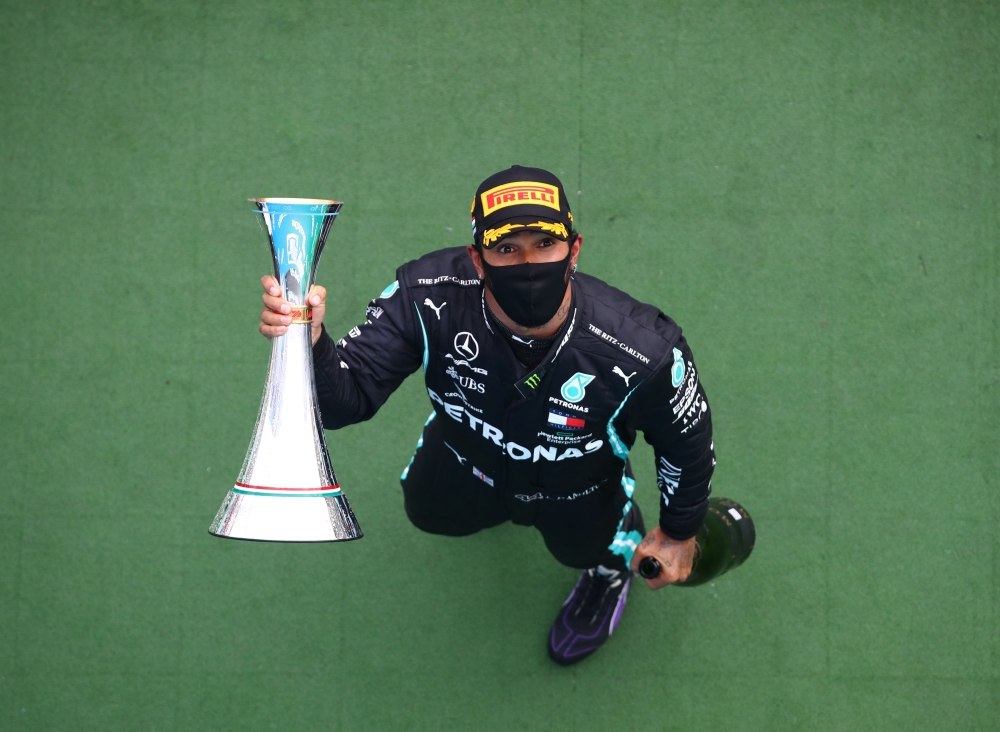 Mercedes' British driver Lewis Hamilton celebrates with the trophy after winning the Formula One Hungarian Grand Prix race at the Hungaroring circuit in Mogyorod near Budapest, Hungary, on July 19, 2020. / AFP / POOL / Mark Thompson