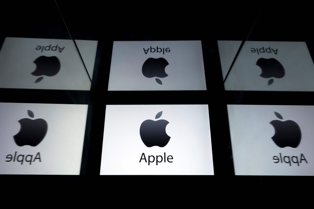 In this file photo taken on February 17, 2019 This illustration picture shows the US multinational technology company Apple logo displayed on a tablet in Paris on February 18, 2019. / AFP / Lionel BONAVENTURE