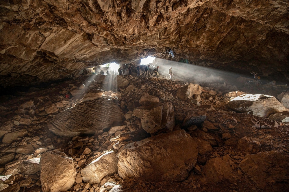 Researchers entering at a cave in Zacatecas in central Mexico, which contained stone tools and other evidence of the presence of prehistoric human populations, are seen in this image released on July 22, 2020. Devlin A. Gandy/Handout
