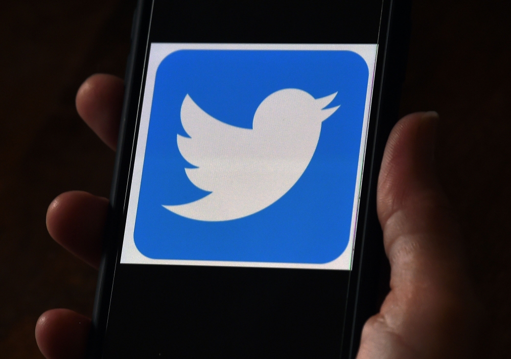 In this file photo illustration, a Twitter logo is displayed on a mobile phone on May 27, 2020, in Arlington, Virginia. Twitter said on July 23, 2020, user growth soared in the past quarter even as ad revenues took a hit amid civil unrest in the US. The s
