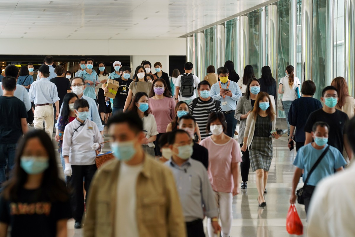 People wearing face masks following the coronavirus disease (COVID-19) outbreak walk at a shopping mall in Hong Kong, China July 20, 2020. REUTERS/Lam Yik
