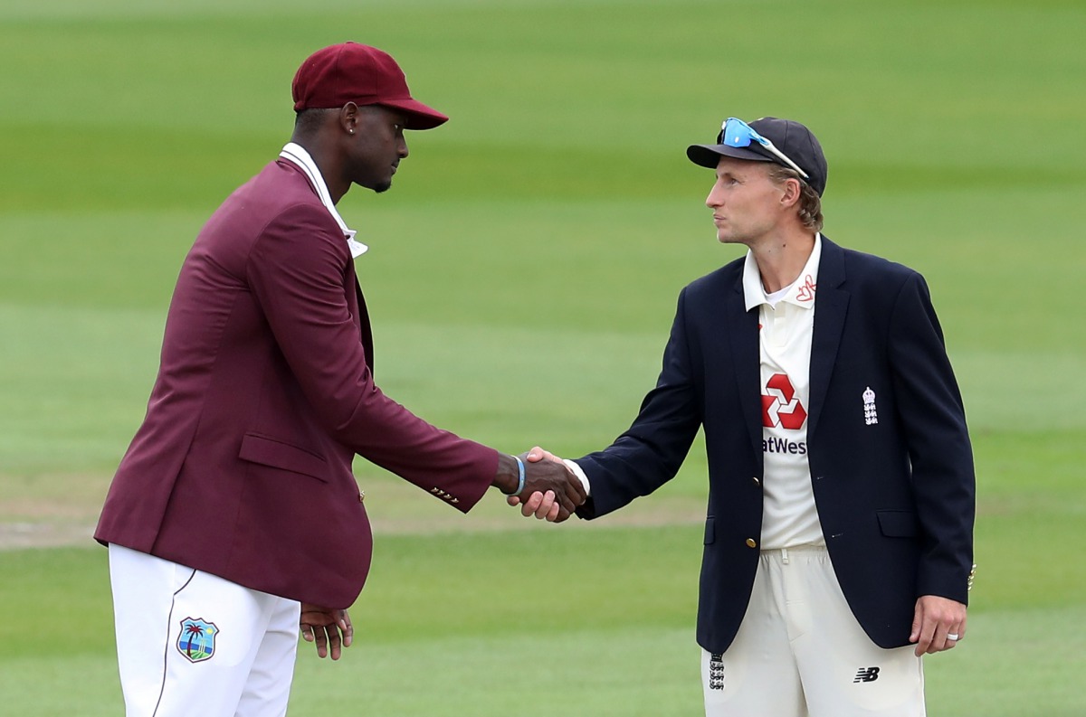 Third Test - England v West Indies - Emirates Old Trafford, Manchester, Britain - July 24, 2020 England's Joe Root and West Indies' Jason Holder shake hands after the coin toss before the start of play, as play resumes behind closed doors following the ou
