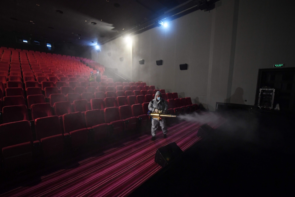 A member of the Blue Sky Rescue team disinfects a cinema in Beijing ahead of its reopening on July 24, 2020. Cinemas in most of China began reopening on July 20 after months of closures due to the COVID-19 coronavirus, with Beijing cinemas allowed to reop