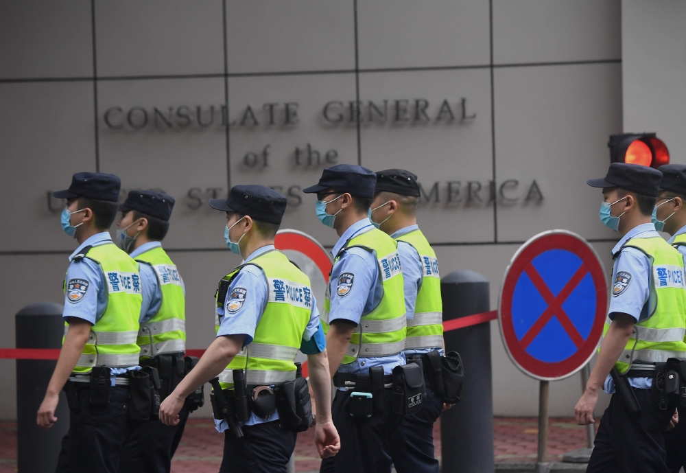 Policemen walk past the US consulate in Chengdu, in Sichuan province on July 25, 2020.  AFP / Noel Celis