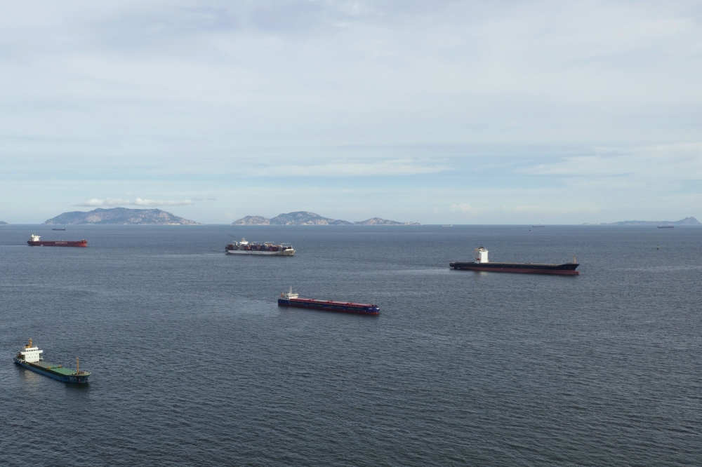 This aerial photo taken on July 25, 2020 shows Liberian cargo ships Rosa (R) and Alisa V (2nd R), two of six vessels under a quarantine order after some crew members tested positive for the COVID-19 coronavirus, anchored off the shore of Hong Kong's Lamma