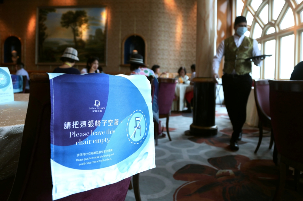 Social distancing signs are seen in the restaurant to prevent the spread of the coronavirus disease (COVID-19), on the Explorer Dream cruise ship, in Keelung, Taiwan, July 26, 2020. REUTERS/Ann Wang