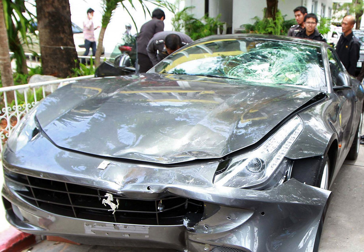(FILES) In this file photo taken on September 3, 2012, police officers look at a Ferrari that was allegedly involved in a hit-and-run accident during their investigation at Thong Lor police station in Bangkok. / AFP /STR
