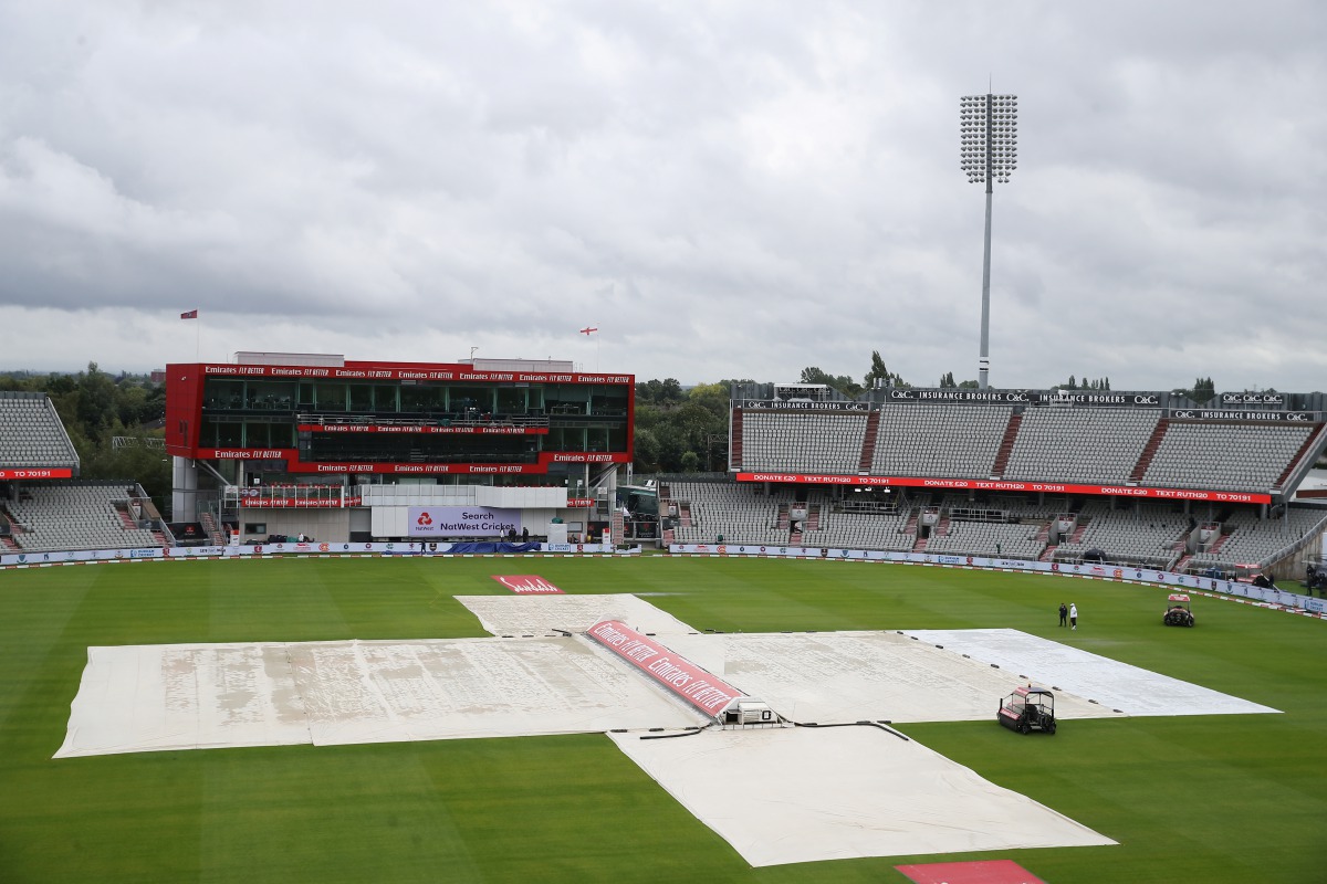 England v West Indies - Emirates Old Trafford, Manchester, Britain - July 27, 2020 The umpires inspect the pitch as rain delays the start of play Martin Rickett/Pool via REUTERS
