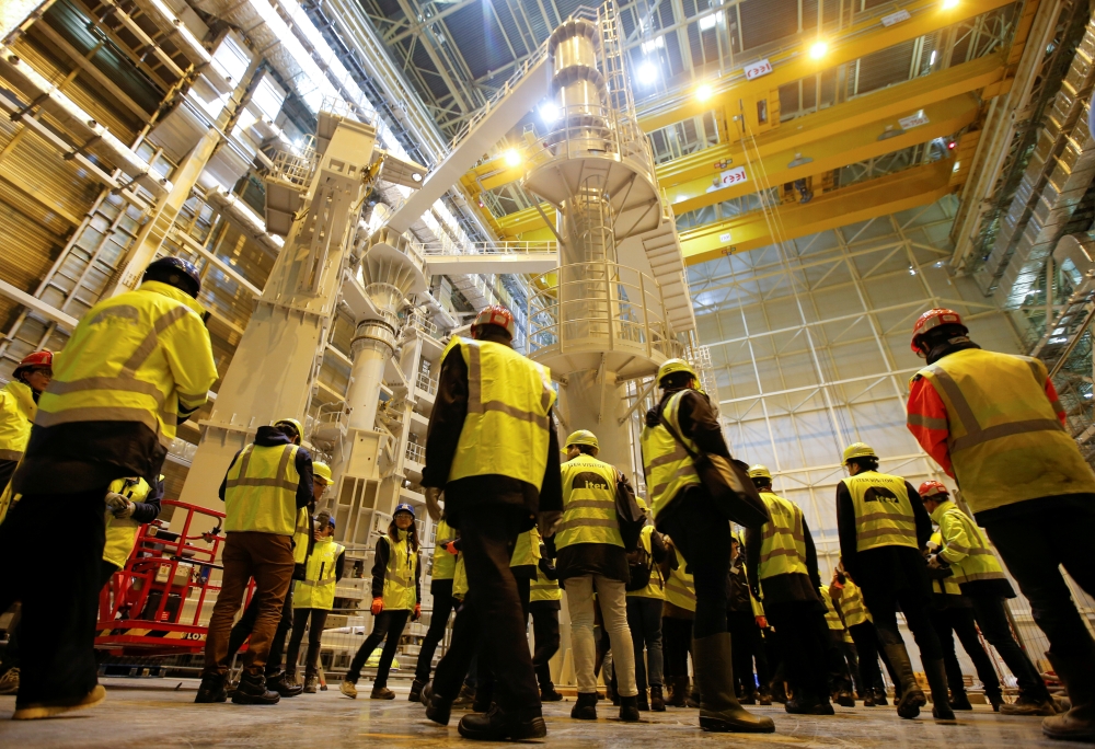 FILE PHOTO: Technicians and visitors stand inside the International Thermonuclear Experimental Reactor (ITER) assembly hall in Saint-Paul-lez-Durance, southern France, November 7, 2019. REUTERS/Jean-Paul Pelissier/File Photo
