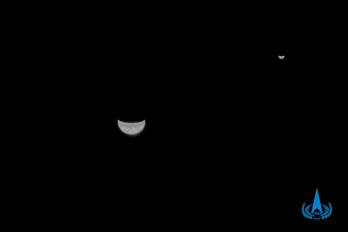 This handout photograph taken on July 27, 2020 and released by the China National Space Administration via CNS, shows a view of the Earth and Moon taken by China's Tianwen-1 Mars probe from a distance of 1.2 million kilometers. AFP PHOTO / China National 