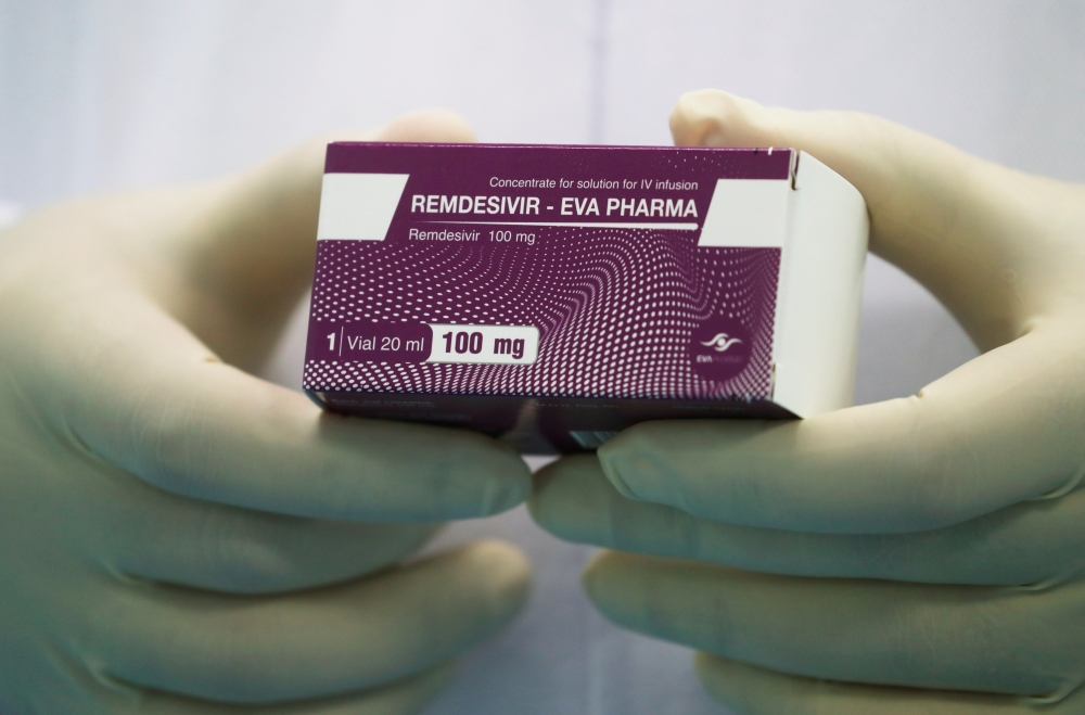 FILE PHOTO: A lab technicians holds the coronavirus disease (COVID-19) treatment drug 