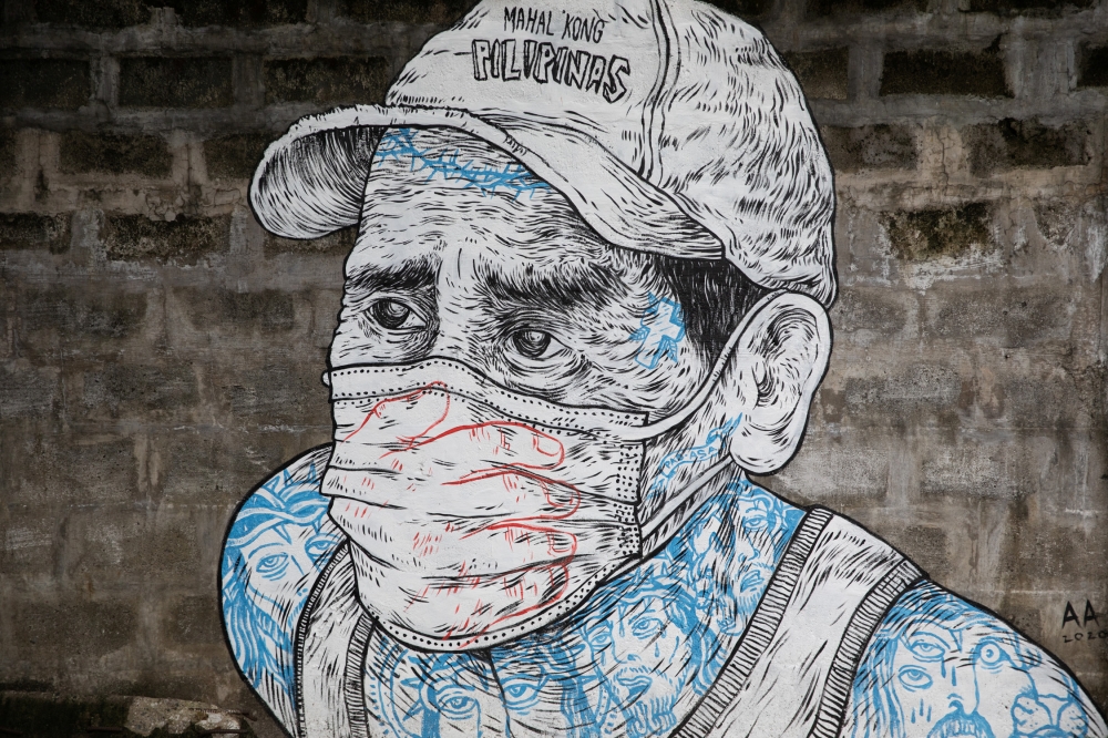 A mural of a man wearing a mask is pictured on a sidewalk amid the coronavirus disease (COVID-19) outbreak in Quezon City, Metro Manila, Philippines, July 30, 2020. REUTERS/Eloisa Lopez NO RESALES. NO ARCHIVES.