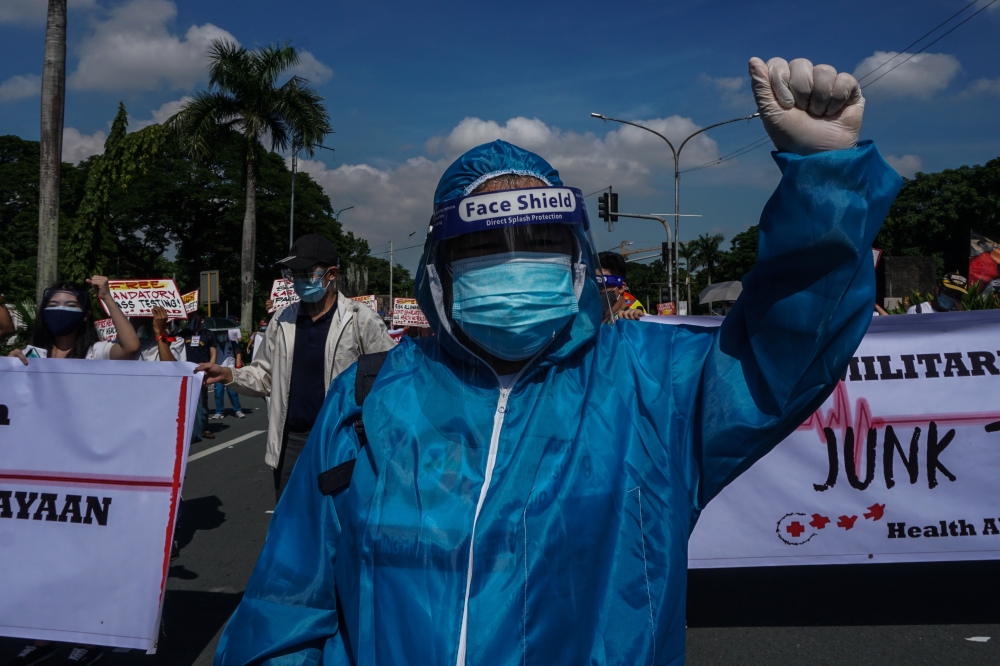 People carrying banners gather to protest as Philippine President Rodrigo Duterte delivers his State of the Nation Address (SONA), at Commonwealth Avenue, near University of the Philippines in Quezon City, Philippines on July 27, 2020. DANTE DIOSINA JR - 
