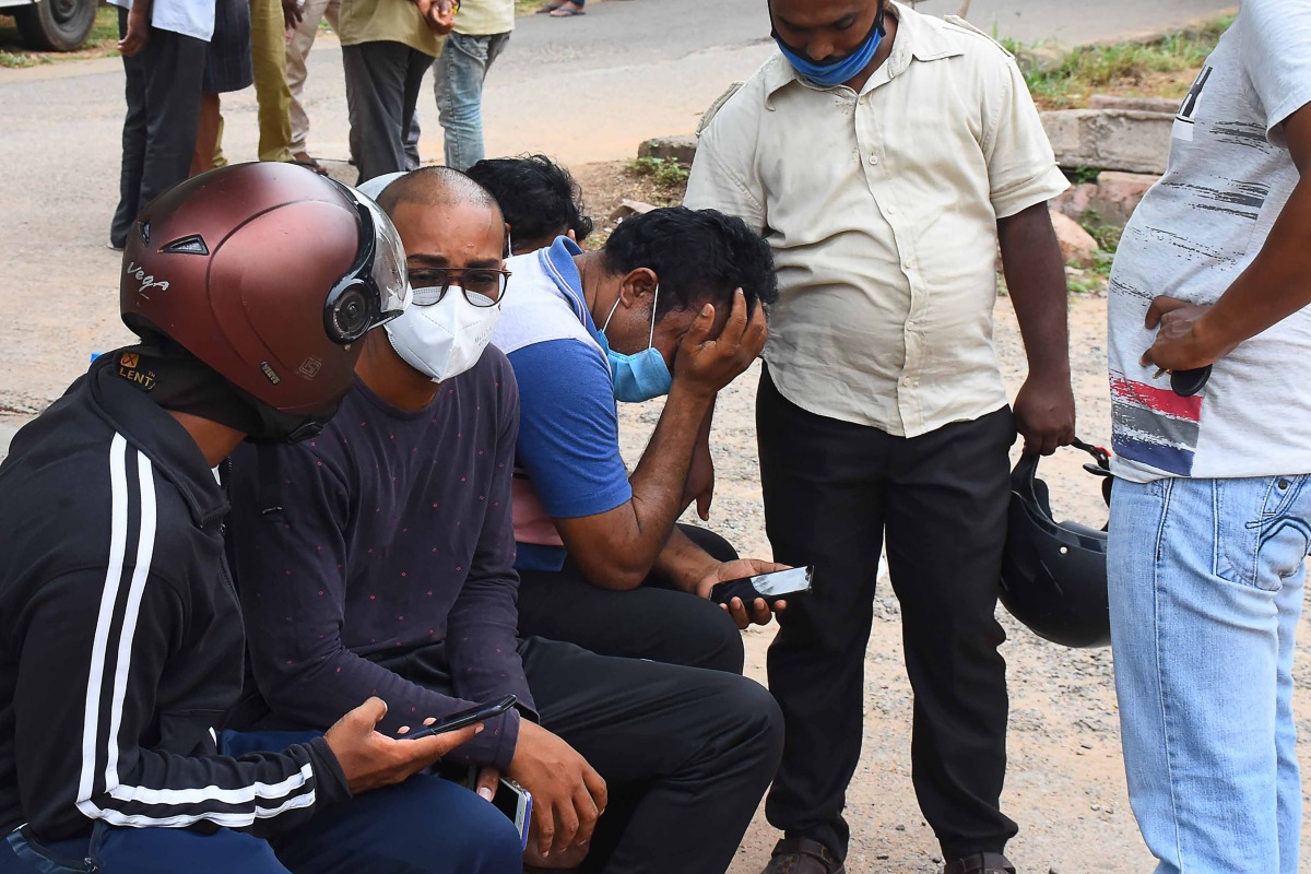 Relatives of the victims of an accident where a crane collapsed after its cabin and base snapped during a trial run, react at a hospital in Visakhapatnam on August 1, 2020. / AFP / STR
