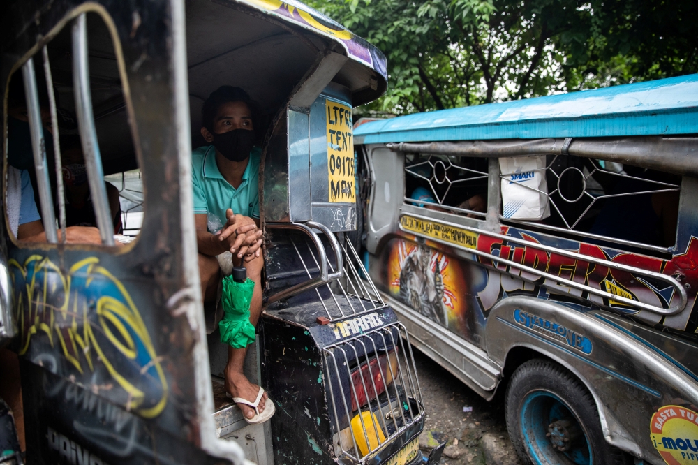 A jeepney driver who lost his livelihood amid the coronavirus disease (COVID-19) outbreak takes shelter inside a jeepney, in Quezon City, Metro Manila, Philippines, July 30, 2020. REUTERS/Eloisa Lopez