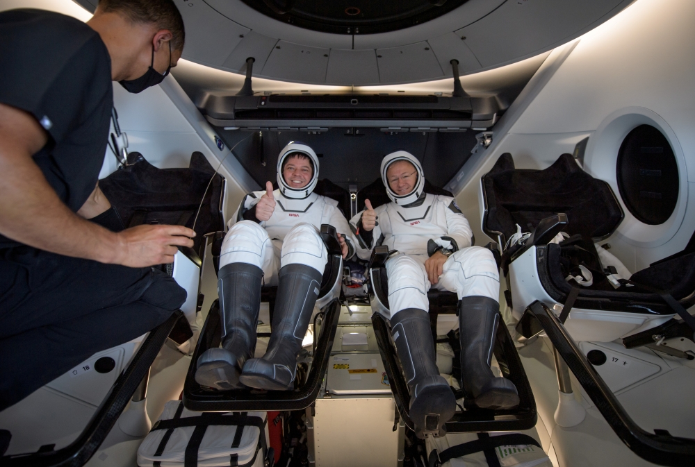 NASA astronauts Robert Behnken, left, and Douglas Hurley are seen inside the SpaceX Crew Dragon Endeavour spacecraft onboard the SpaceX GO Navigator recovery ship shortly after having landed in the Gulf of Mexico off the coast of Pensacola, Florida, U.S.,