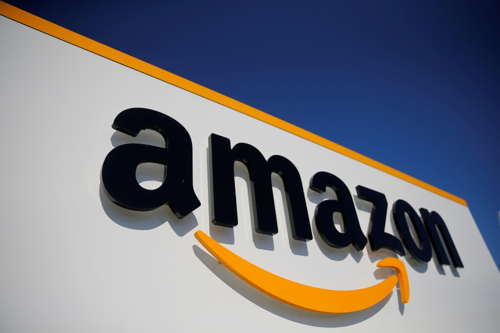 FILE PHOTO: The logo of Amazon is seen at the company logistics center in Lauwin-Planque, northern France, April 22, 2020. REUTERS/Pascal Rossignol/File Photo