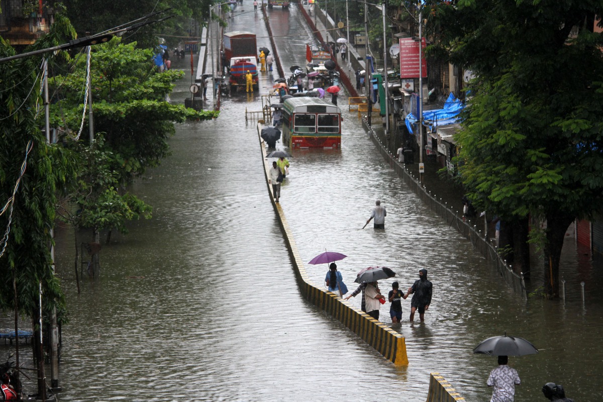 MUMBAI, INDIA - AUGUST 4: People make their way through a flooded road due to heavy monsoon rain in Mumbai, India on August 4, 2020. ( Imtiyaz Shaikh - Anadolu Agency )
