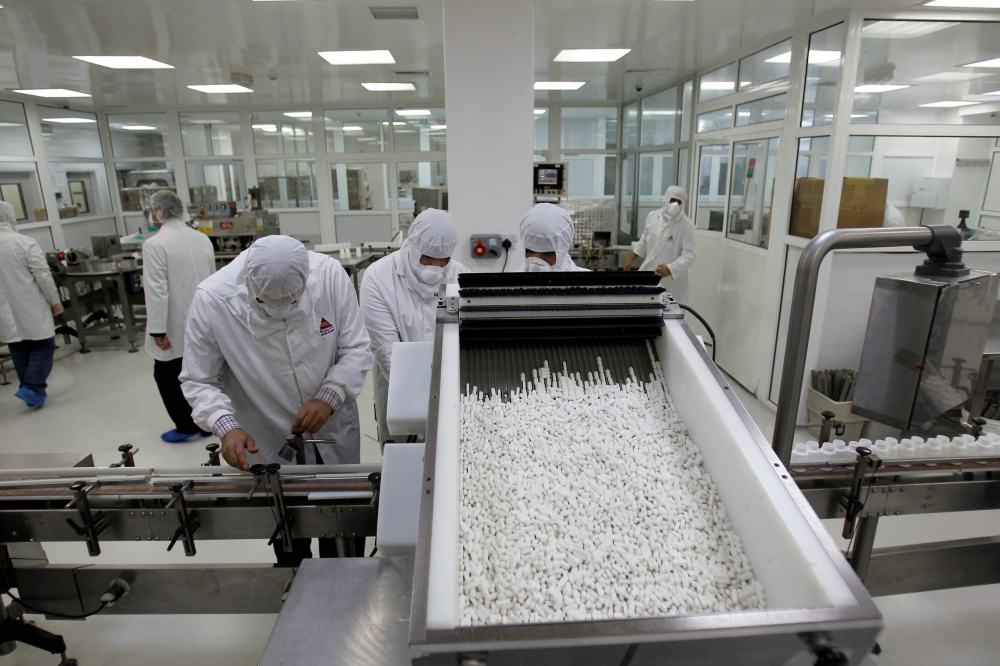 FILE PHOTO: Pharmacists at a Hikma Pharmaceuticals plant package tablets, February 8, 2011. Picture taken February 8, 2011. REUTERS/Ali Jarekji/File Photo