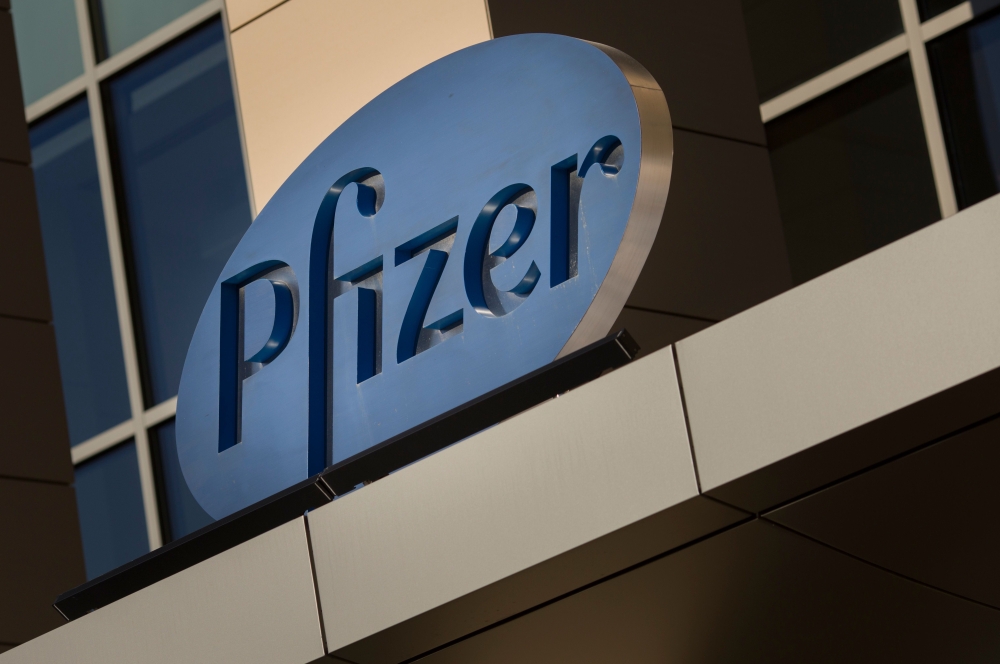 In this file photo a sign for Pfizer pharmaceutical company is seen on a building in Cambridge, Massachusetts, on March 18, 2017. Canada announced August 5, 2020 it has signed two agreements with American pharmaceutical firms Pfizer and Moderna for the de