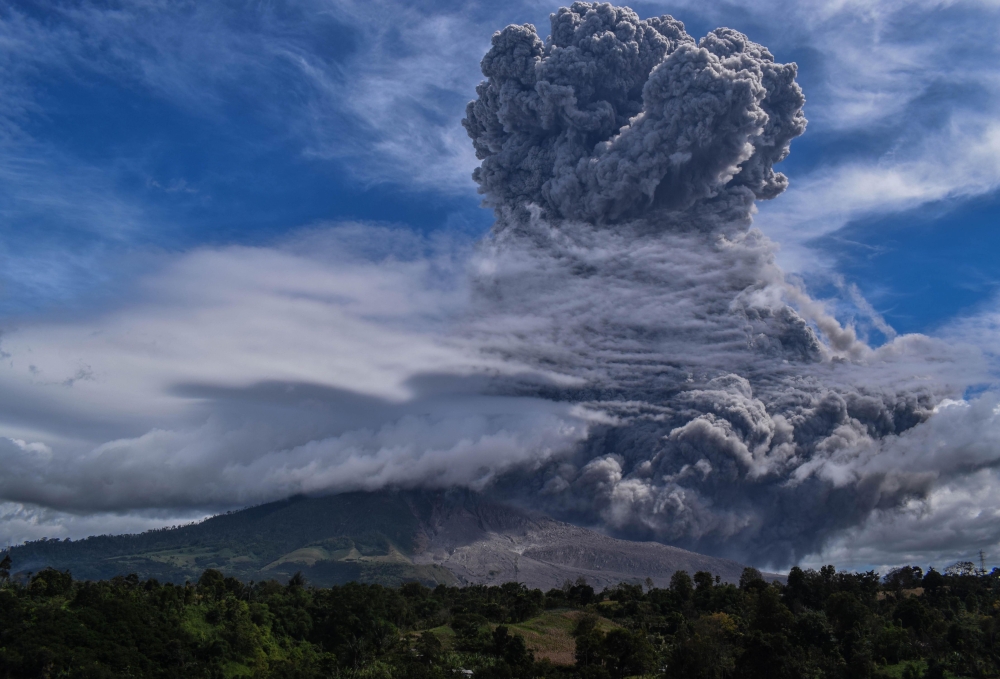Mount Sinabung spews thick ash and smoke into the sky in Karo, North Sumatra on August 10, 2020. / AFP / Anto Sembiring