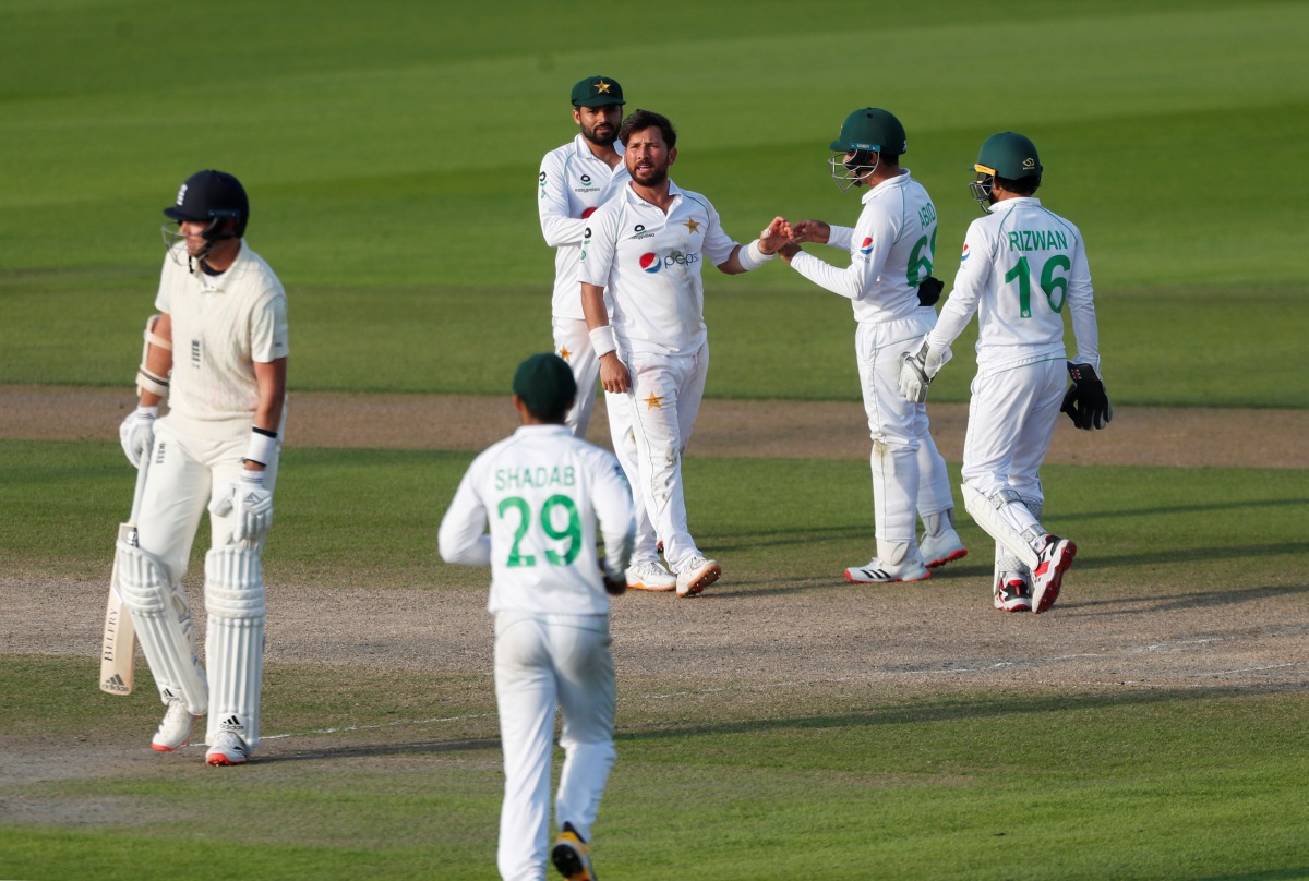 Cricket - First Test - England v Pakistan - Emirates Old Trafford, Manchester, Britain - August 8, 2020 Pakistan's Yasir Shah celebrates the wicket of England's Stuart Broad with teammates, as play resumes behind closed doors following the outbreak of the