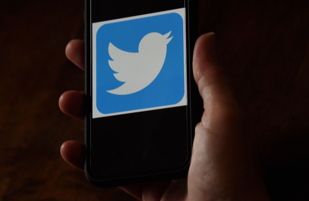 In this file illustration photo taken on May 27, 2020, a Twitter logo is displayed on a mobile phone on May 27, 2020, in Arlington, Virginia. / AFP / Olivier DOULIERY