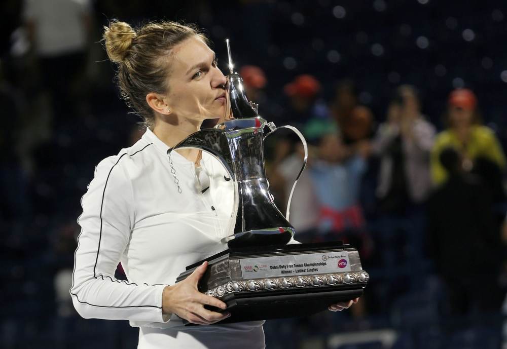 February 22, 2020 Romania's Simona Halep poses with a trophy as she celebrates after winning the final against Kazakhstan's Elena Rybakina REUTERS/Satish Kumar Subramani/File Photo