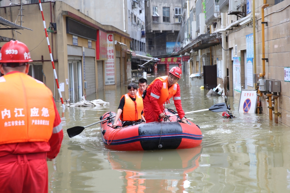 Rescue workers evacuate a resident stranded by floodwaters following heavy rainfall in Neijiang of Sichuan province, China August 18, 2020. China Daily via REUTERS