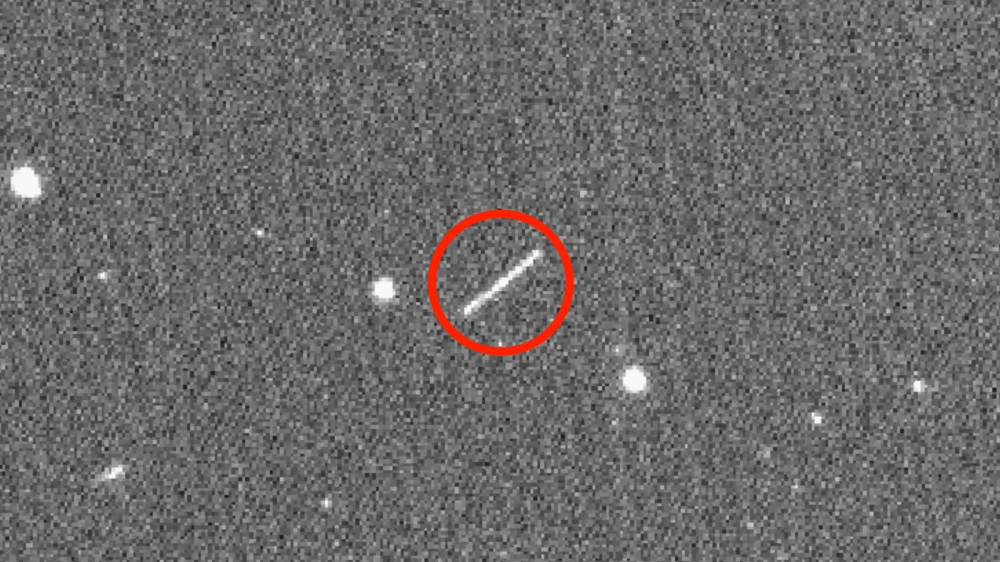 This NASA/JPL/ZTF/Caltech Optical Observatories handout image obtained on August 18, 2020 shows asteroid 2020 QG (the circled streak in the center) which came closer to Earth than any other nonimpacting asteroid on record. It was detected by the Zwicky Tr