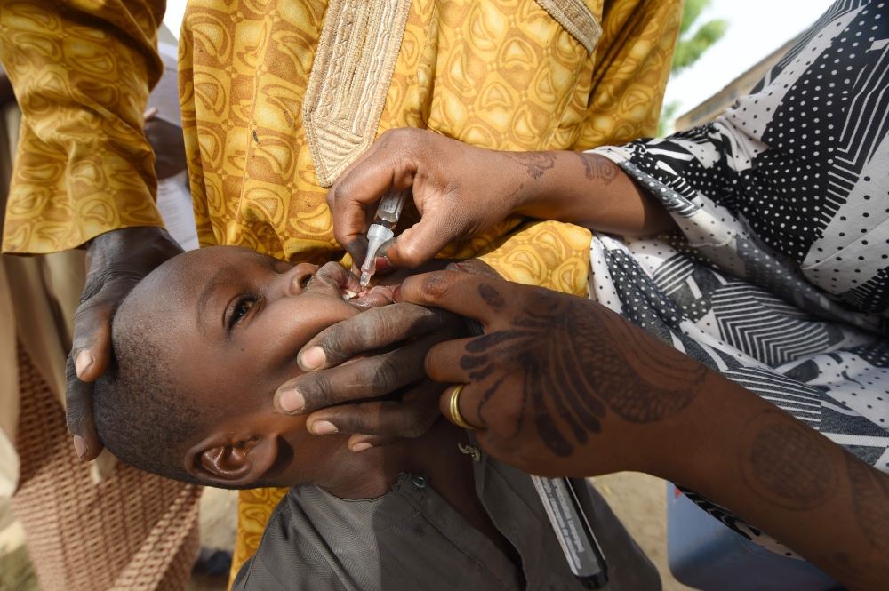 In this file photo taken on April 22, 2017 A Health worker administers a vaccine to a child during a vaccination campaign against polio at Hotoro-Kudu, Nassarawa district of Kano in northwest Nigeria. The World Health Organization (WHO) is to certify the 